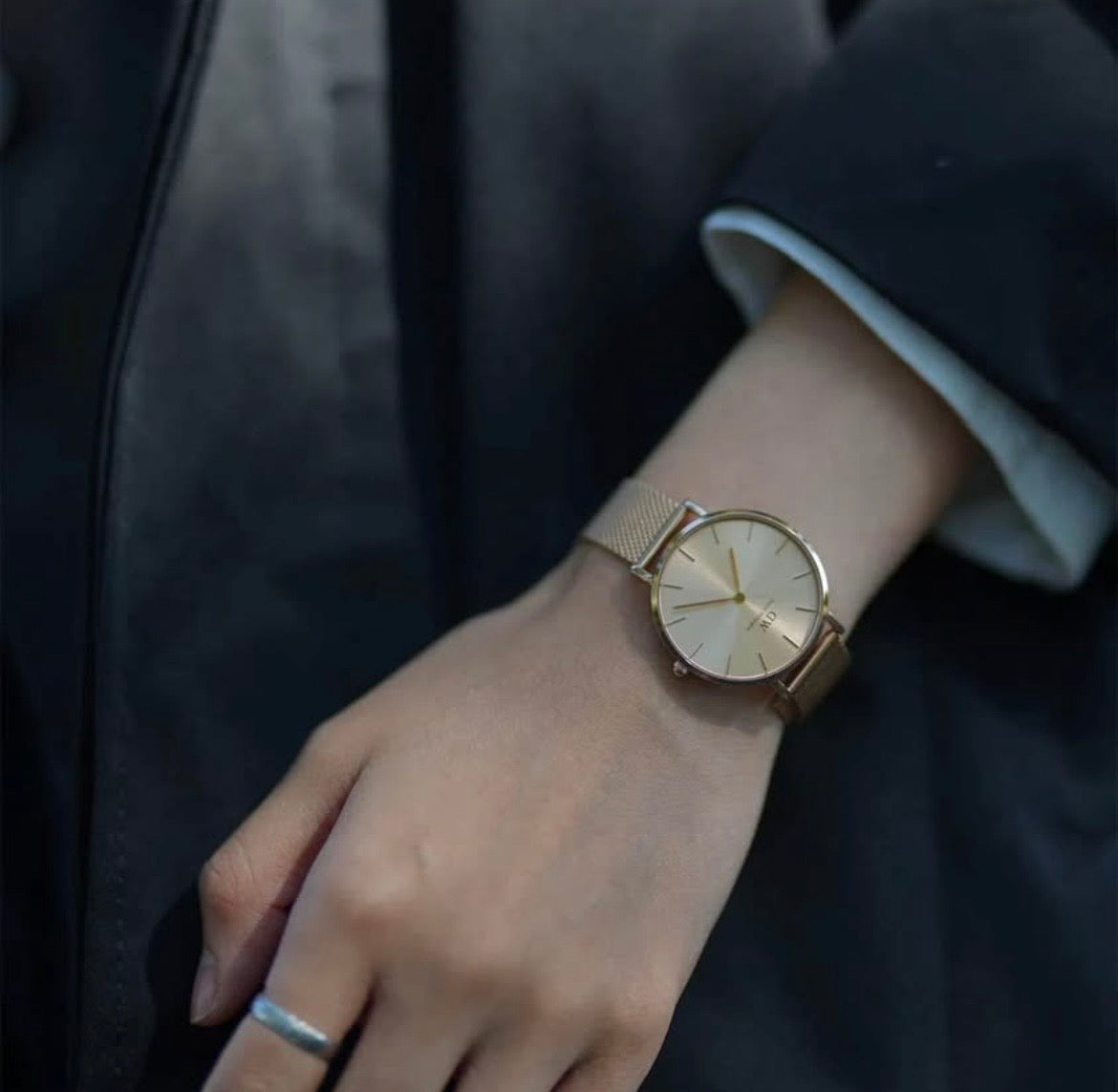 Gold Daniel Wellington Petite Unitone women's watch with a minimalist dial and a fine 36mm